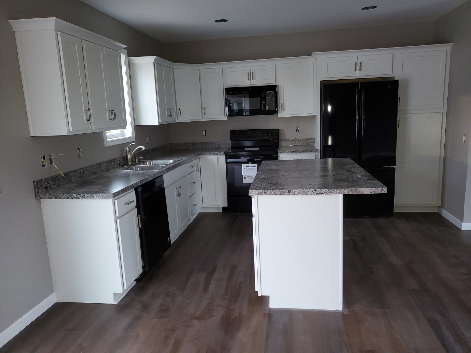 Rebuilt kitchen with white cabinets and island