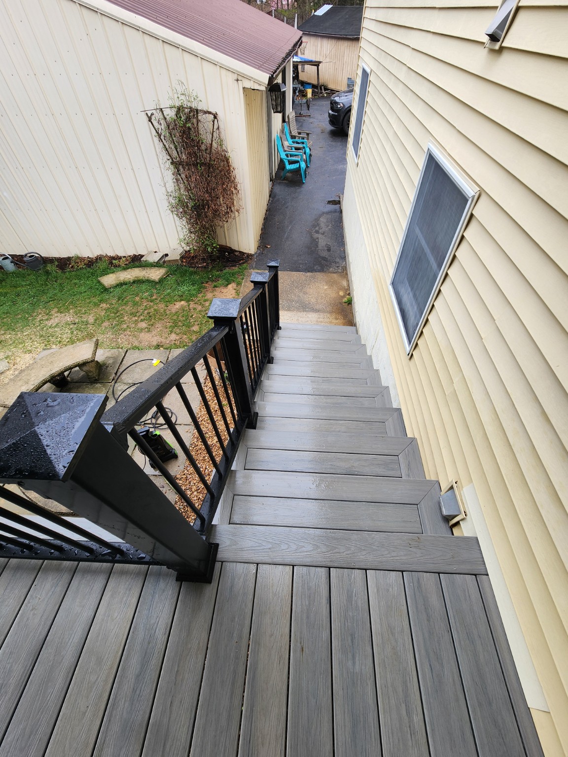 Finished porch stairs with gray treads and black railings