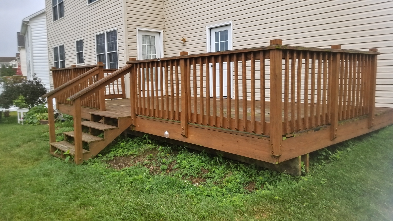 Before: existing wood deck and wooden railings